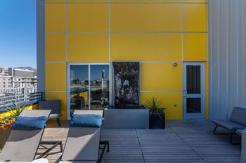 A yellow building with a glass door and windows.